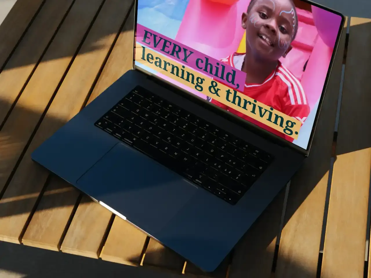 Laptop showing Mizizi Elimu Afrika branding
