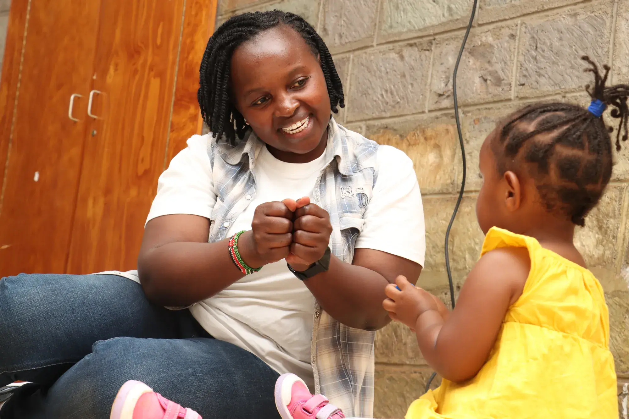 Mother carrying child on her back outdoors