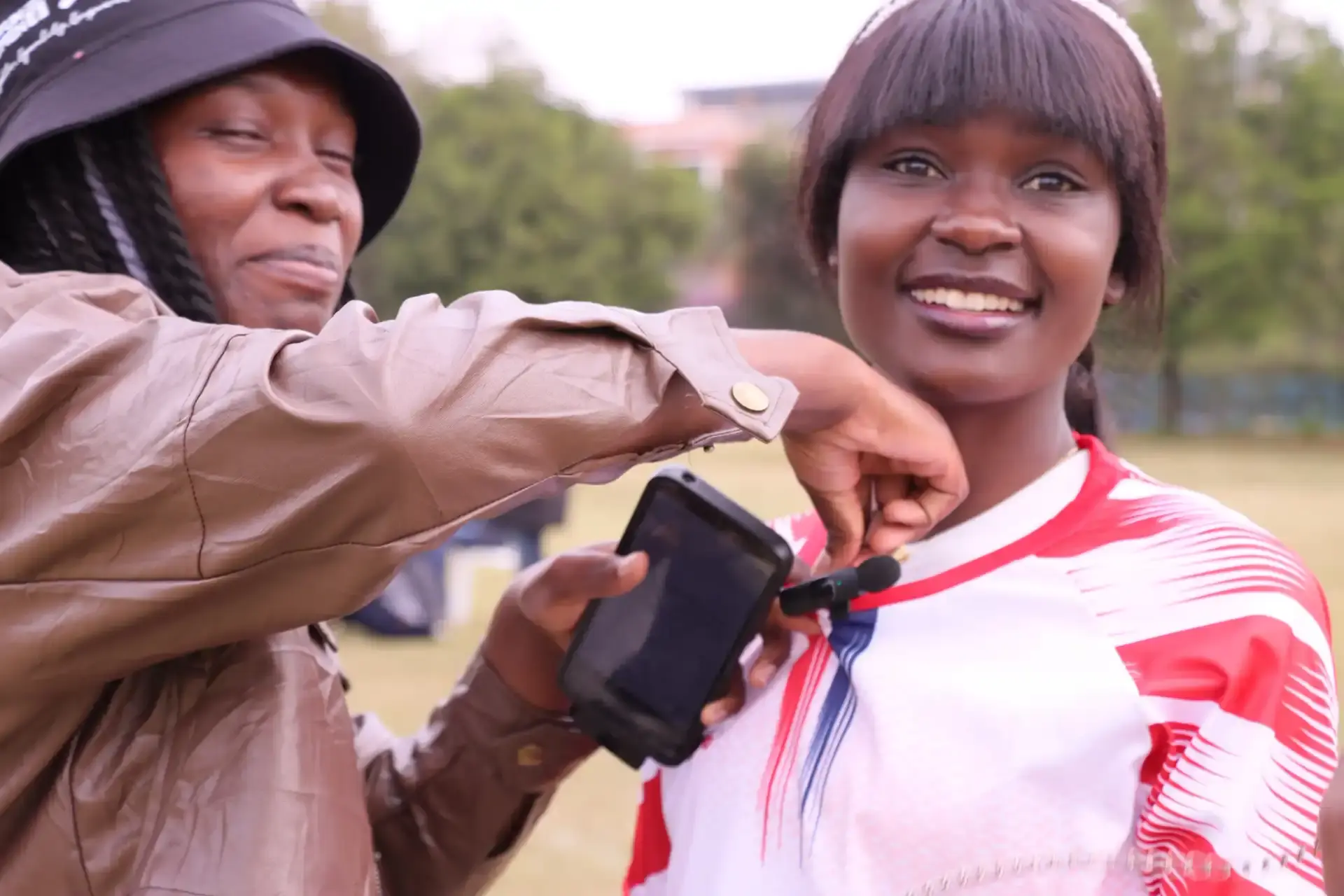 Young woman with a camera smiling