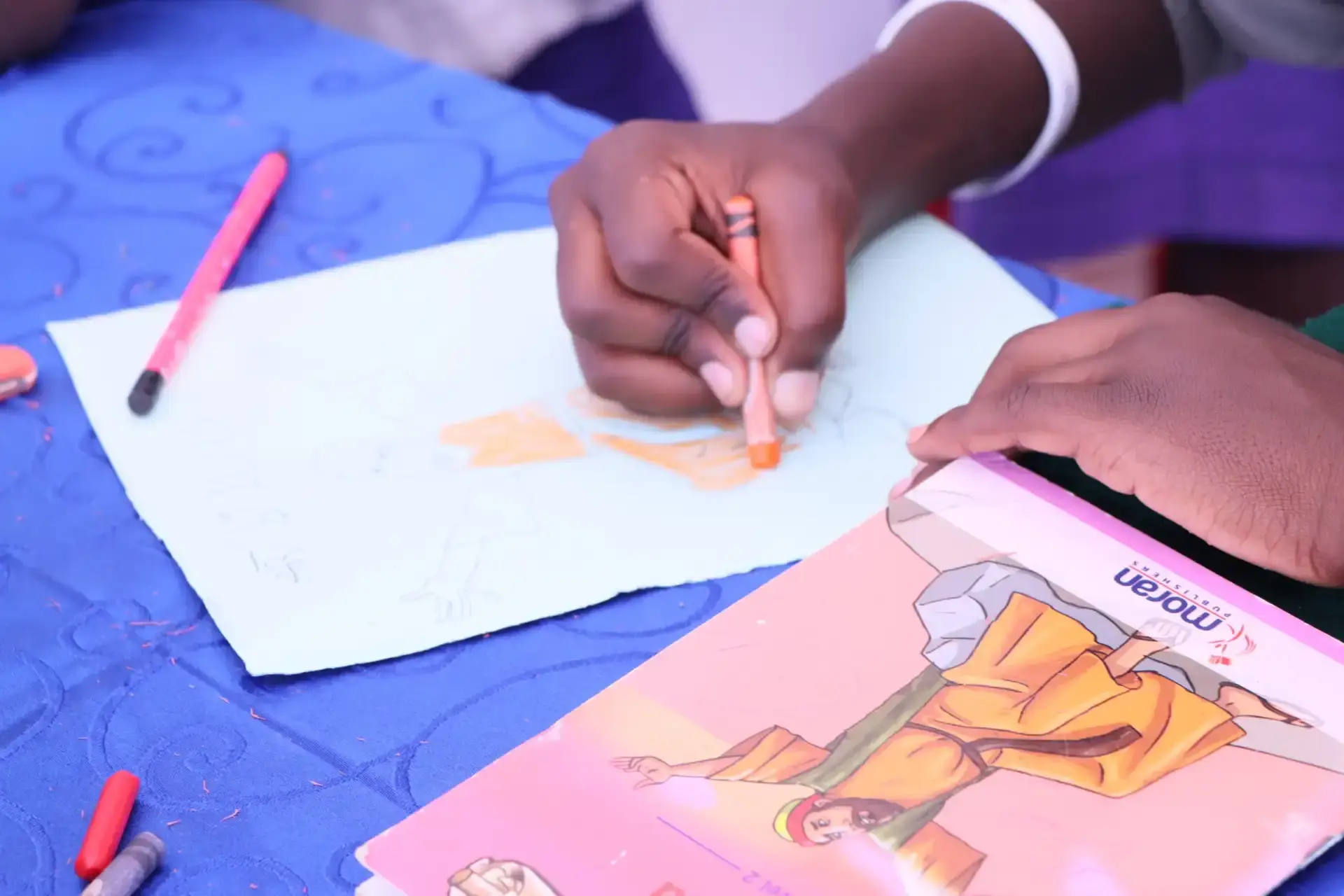 Child drawing with crayons